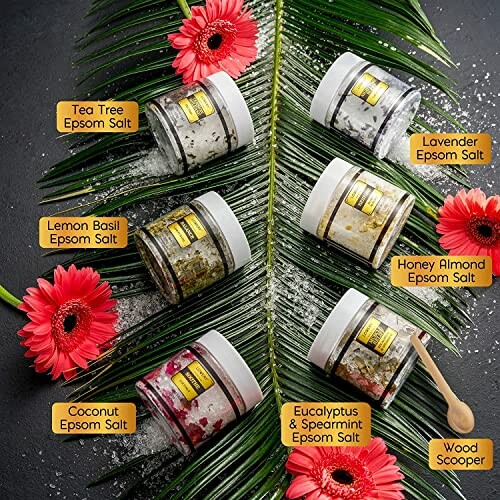 Variety pack of Epsom salts with different scents on palm leaves.