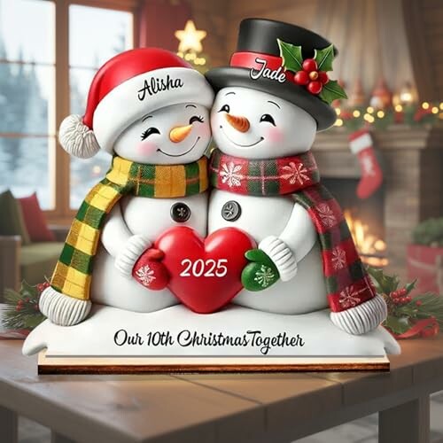 Snowman couple figurine with a heart labeled 2025, celebrating 10th Christmas together.